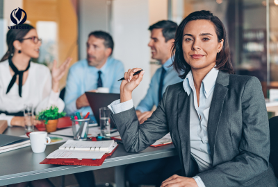 Confident female leader in sharp suit commanding attention during a Verbossa strategy meeting